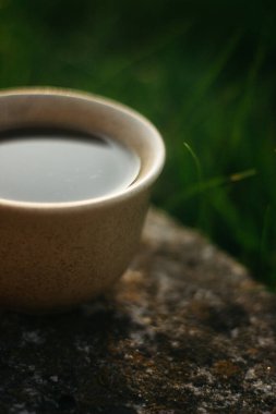 a cup of coffee on the background of the sunset.cup of coffee in the sunset
