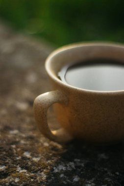 a cup of coffee on the background of the sunset.cup of coffee in the sunset