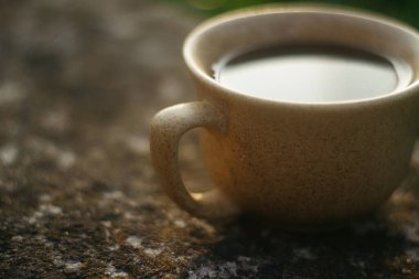 a cup of coffee on the background of the sunset.cup of coffee in the sunset