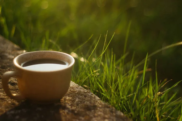 a cup of coffee on the background of the sunset.cup of coffee in the sunset