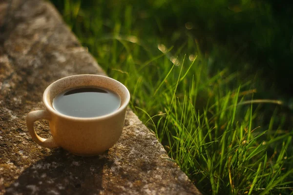 a cup of coffee on the background of the sunset.cup of coffee in the sunset