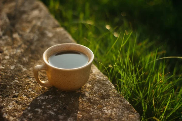 a cup of coffee on the background of the sunset.cup of coffee in the sunset