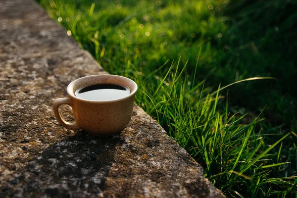 a cup of coffee on the background of the sunset.cup of coffee in the sunset