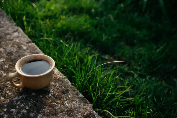 a cup of coffee on the background of the sunset.cup of coffee in the sunset