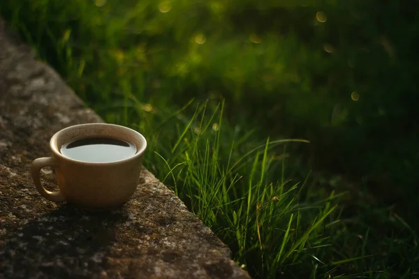 a cup of coffee on the background of the sunset.cup of coffee in the sunset