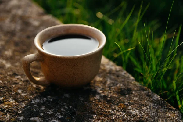 a cup of coffee on the background of the sunset.cup of coffee in the sunset