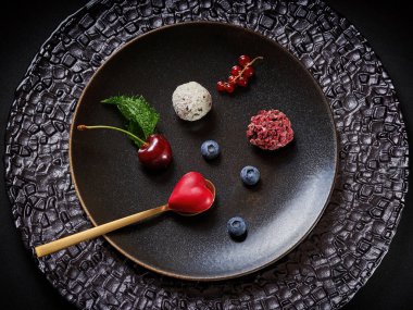 Kahverengi tabakta altın kaşıkla olgun böğürtlen ve şekerler. Üst görünüm           