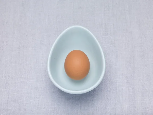Egg in an oval egg shaped bowl — Stock Photo, Image