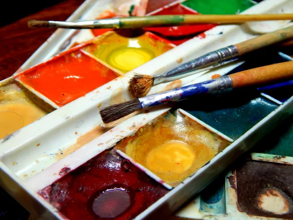 Paints and brushes close — Stock Photo, Image