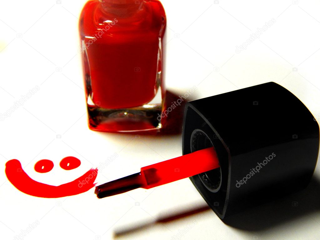 Red nail polish, brush and a smiley face