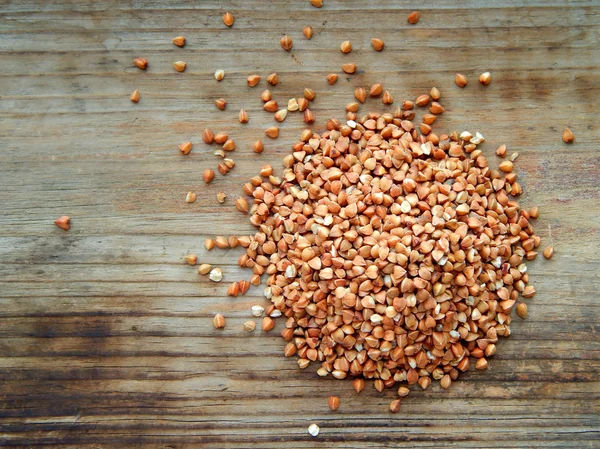 Buckwheat grains on wooden table — Stock Photo, Image