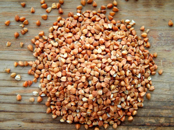 Buckwheat grains on wooden table — Stock Photo, Image