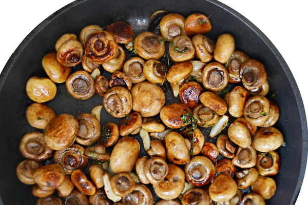 Roasted mushrooms champignons with thyme and garlic in a pan isolated on white — Stock Photo, Image