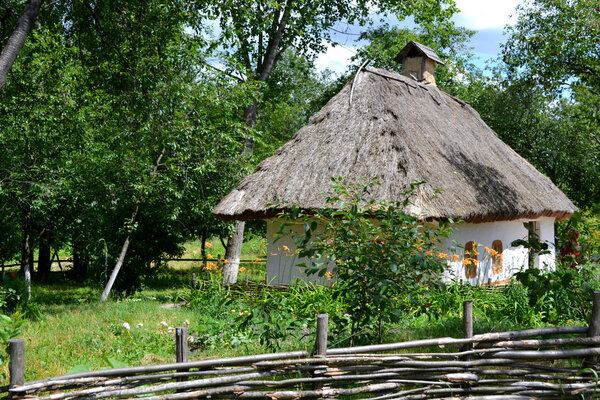 Old traditional Ukrainian house hata made from wood and straw