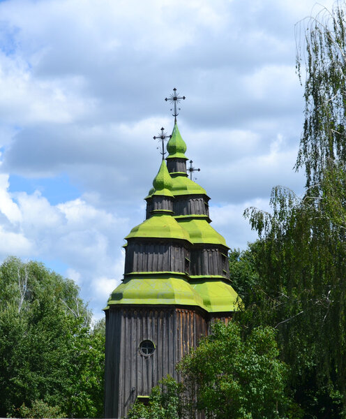 Wooden church with green domes in Ukraine