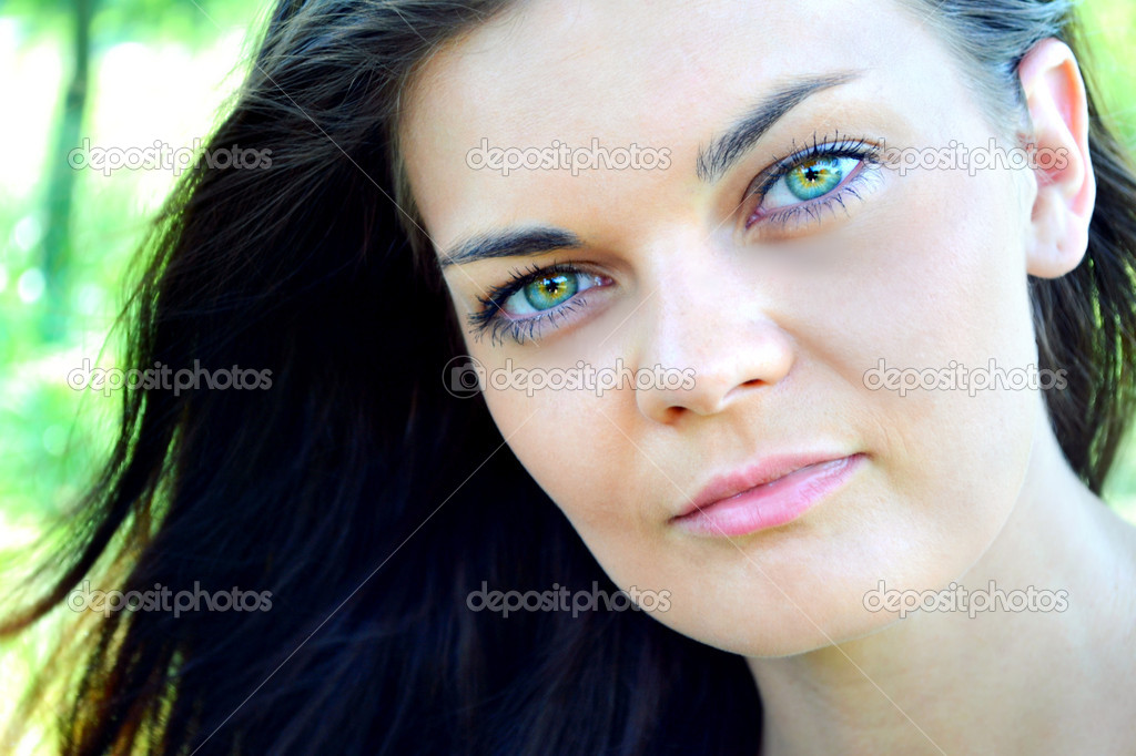 Young And Beautiful Brunette Woman With Bright Green Eyes Stock Photo