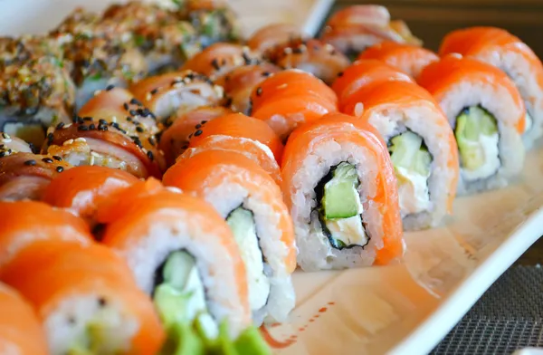 Heerlijke broodjes en sushi met paling, zalm en philadelphia — Stockfoto