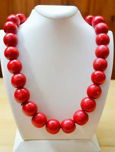 Traditional Ukrainian round red bead made from wood on white mannequin isolated — Stock Photo, Image