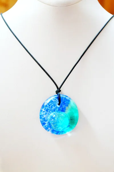 Pendant with blue glass circle on a mannequin — Stock Photo, Image