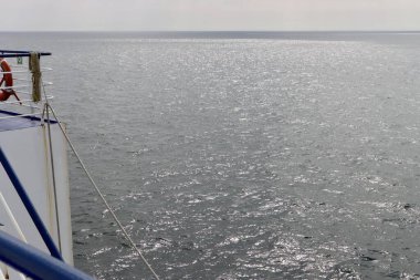 Baltık Denizi 'nin pürüzsüz yüzeyi. Derin mavi su, güneş ışığının yansımaları. Fotoğraf gemiden çekilmiş.