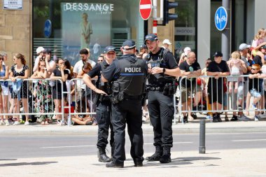 Group of three policemen and women discussing during National day celebrations. Luxembourg, Luxembourg - June 23, 2022