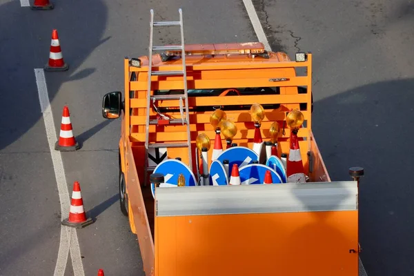 Orange Van Transporting Blue Roadsigns Hazard Led Blinkers Traffic Cones — Zdjęcie stockowe