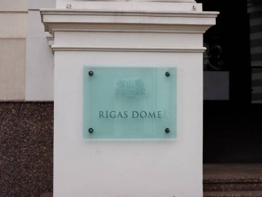 Glass plaque of Riga city council with name in Latvian and coat of arms. Riga, Latvia - May 28, 2022