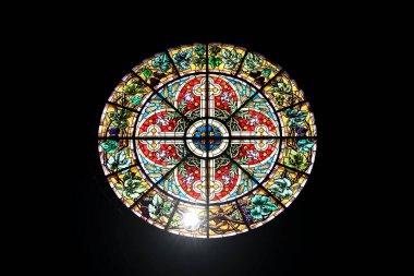 The main Rose window of Riga Cathedral - stained glass with cross and flower design. Dome Cathedral, Riga, Latvia - July 21, 2022