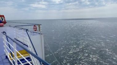 Smooth surface of far open Baltic sea. Deep blue water, reflections of sun light. Video taken from ship. Travemunde, Germany - May 19, 2022