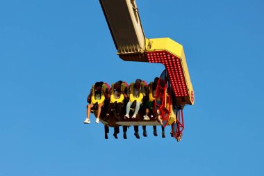 Magic carpet thrill ride with people in Schueberfouer fun fair in Luxembourg, Luxembourg - August 28, 2022