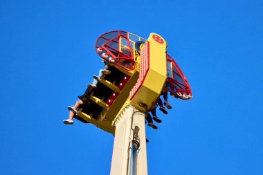 Magic carpet thrill ride with people in Schueberfouer fun fair in Luxembourg, Luxembourg - August 28, 2022