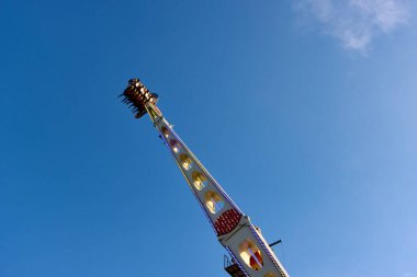 Magic carpet thrill ride with people in Schueberfouer fun fair in Luxembourg, Luxembourg - August 28, 2022