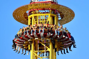 Top of Hangover the Tower Ride with people in it. Schueberfouer fun fair in Luxembourg, Luxembourg - August 28, 2022