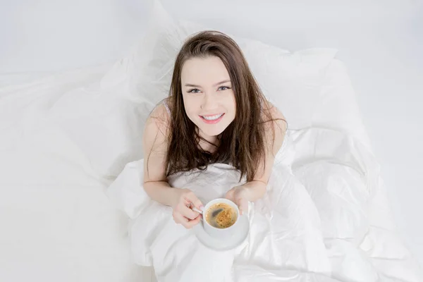 Woman Sits Bed Drinks Aromatic Coffee Looks Smiles Brunette Holding Stock Image