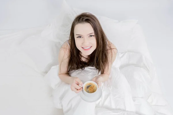 Woman Sits Bed Drinks Aromatic Coffee Looks Smiles Brunette Holding Stock Picture