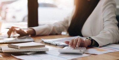 Finans, vergi, muhasebe, istatistik ve analitik araştırma konseptini hesaplamak için hesap makinesi ve dizüstü bilgisayar kullanan İşadamı kapat