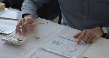 İş adamları gelir-gider hesapları yapıyor ve emlak yatırım verileri, Muhasebe Finans ve vergi sistemleri kavramını analiz ediyorlar