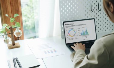 Diz üstü bilgisayarla ahşap masada çalışan kadın serbest görüşü.