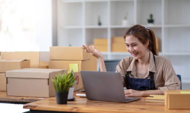 Female entrepreneurs Small Business SME Independent work at home, using laptops for commercial checking, online marketing, packing boxes, SME sellers concept, online sales