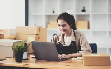 Female entrepreneurs Small Business SME Independent work at home, using laptops for commercial checking, online marketing, packing boxes, SME sellers concept, online sales