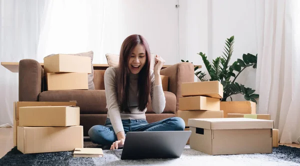 Portrait of Starting small businesses SME owners female entrepreneurs working on receipt box and check online orders to prepare to pack the boxes, sell to customers, SME business ideas online