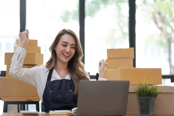 Portrait of Starting small businesses SME owners female entrepreneurs working on receipt box and check online orders to prepare to pack the boxes, sell to customers, SME business ideas online