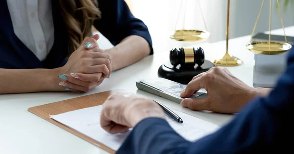 Close-up shot, A male client giving a house loan payment or mortgage fees to his female real estate agent. Property Investment concep