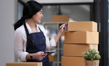 Entrepreneurs Small Business SME Independent men work at home Use smartphones and laptops for commercial checking, online marketing, packing boxes, SME sellers, concept, e-commerce team, online sale
