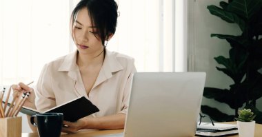 beautiful young asian businesswoman working together using digital tablet at office.