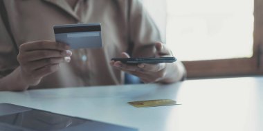 Woman hands holding smartphone shopping online with credit card. Online Payment. Online shopping concept