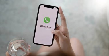CHIANG MAI, THAILAND - JAN 23 2022 : Young man with smartphone in her hands. whatsapp on the screen. iPhone xs plus was created and developed by the Apple inc