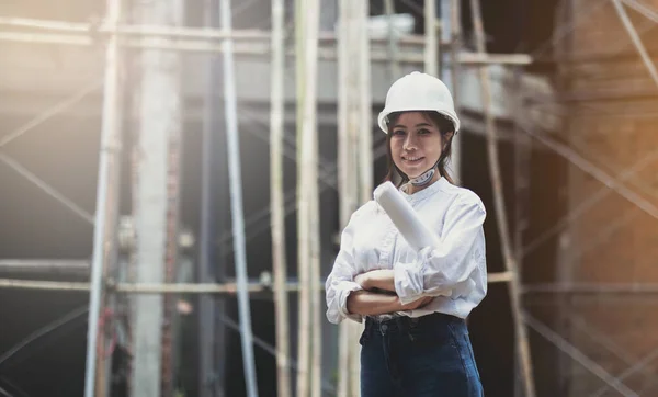 Female construction engineer. Portrait of a young woman working at a construction site