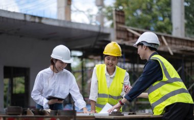 Three experts inspect commercial building construction sites, industrial buildings real estate projects with civil engineers, investors use laptops in background home, concrete formwork framing