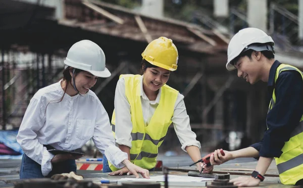 Three experts inspect commercial building construction sites, industrial buildings real estate projects with civil engineers, investors use laptops in background home, concrete formwork framing